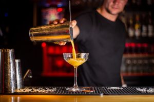 bartender using a Hawthorne strainer