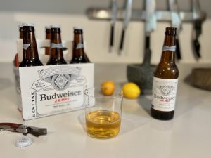 Budweiser zero in glass with 6am pack of bottles
