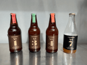 four curious elixirs on a stainless steel table