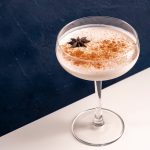 non alcoholic eggnog in a coupe glass with star anise and cinnamon