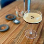 non alcoholic espresso martini with coffee been garnish in a coupe glass