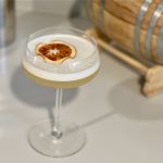 non alcoholic whiskey sour cocktail with small barrel